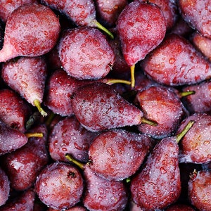 May include: A close-up shot of a pile of ripe, red pears. The pears are covered in tiny water droplets, giving them a fresh, juicy appearance. The pears have a deep red color with a slightly textured skin and green stems.