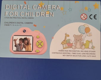 May include: Pink digital camera for children with a screen showing two children smiling. The camera has a variety of features including human face recognition, big head sticker, continuous shooting, timed dual-lens recording, key switch selection lens, and auto save.