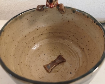 Cup with dog on the edge and bones on the bottom, handmade, stoneware, wheel-turned ceramics, gift, cup with modeled animal, clay