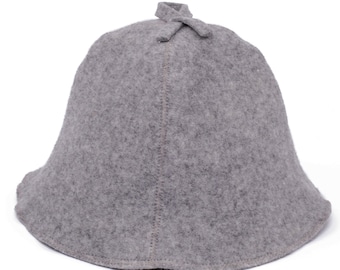 May include: A grey felt hat with a rounded crown and a wide brim. The hat has a small knot at the top.