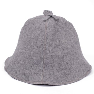 May include: A grey felt hat with a rounded crown and a wide brim. The hat has a small knot at the top.