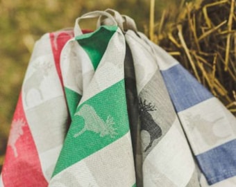 May include: Four kitchen towels with a striped pattern and a moose design. The towels are in red, green, grey, and blue.