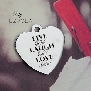 May include: Silver heart-shaped charm with the inscription "Live Well Laugh Often Love Much".