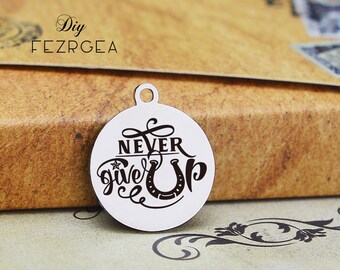 May include: Silver charm with the words "Never Give Up" and a horseshoe in a cursive font.