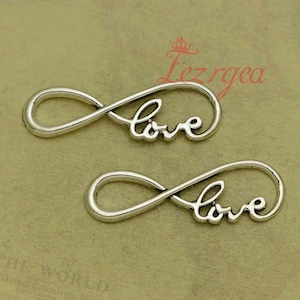 May include: Two silver infinity symbol charms with the word "love" inscribed inside each symbol.