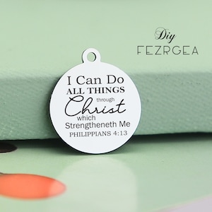 May include: A silver charm with the text "I Can Do All Things Through Christ Which Strengtheneth Me Philippians 4:13".