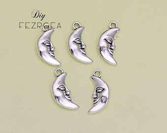 May include: Five silver crescent moon charms with a face on each. The charms have a loop at the top for attaching to jewelry or other crafts.