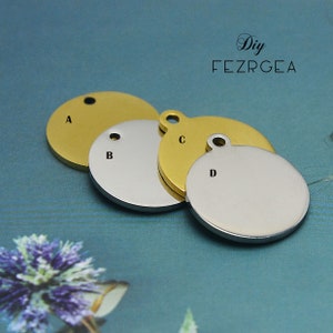 May include: Four round metal tags, two gold and two silver, with holes for attaching to a keychain or necklace. The tags are labeled A, B, C, and D.