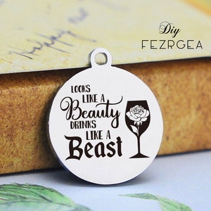 May include: A round silver charm with the text "Looks like a Beauty drinks like a Beast" and a black silhouette of a wine glass with a white rose inside.