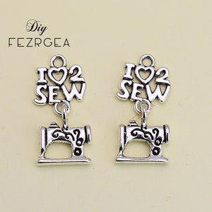May include: Two silver charm pendants with the words "I love to sew" and a small sewing machine charm.