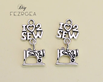 May include: Two silver charm pendants with the words "I love to sew" and a small sewing machine charm.