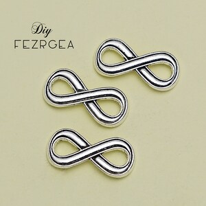 May include: Three silver infinity symbol charms. The charms are smooth and have a shiny finish.