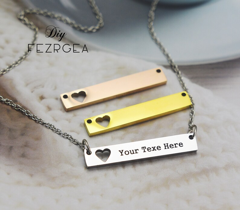 May include: A silver chain necklace with three bar pendants. The top pendant is rose gold, the middle pendant is gold, and the bottom pendant is silver with the text "Your Text Here".