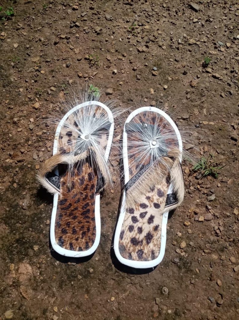 Brown Zulu Imbadada sandals made of genuine springbok hide with leopard print fabric insoles and tyre soles, photographed on a neutral background