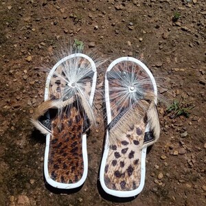 Brown Zulu Imbadada sandals made of genuine springbok hide with leopard print fabric insoles and tyre soles, photographed on a neutral background