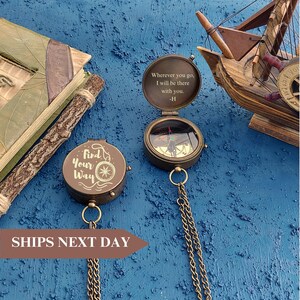 May include: Two antique brass compass pendants with chains. One compass features the words "Find Your Way" and a nautical star design. The other compass has an engraved message: "Wherever you go, I will be there with you. -H"