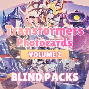 May include: A selection of Transformers photocard blind packs. The cards showcase vibrant illustrations of different Transformers characters. The text "Transformers Photocard Volume 2" is in pink, with "Blind Packs" in white.