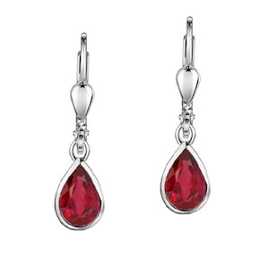 May include: A pair of silver dangle earrings with red teardrop-shaped crystals.