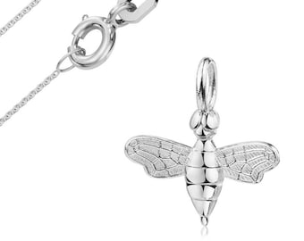 May include: A silver-colored necklace with a bee pendant. The pendant is a detailed, three-dimensional bee with textured wings. The chain and clasp are also silver, and the background is white.