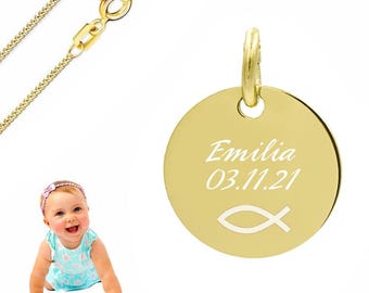 May include: A gold-toned circular pendant necklace featuring the engraved name Emilia, the date 03.11.21, and a fish symbol. The pendant is attached to a delicate gold-toned chain with a lobster claw clasp, presented alongside a baby.