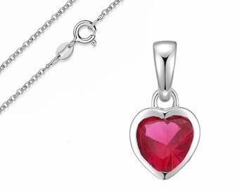 May include: A silver necklace with a heart-shaped pendant. The pendant has a vibrant red gemstone set in a silver frame. The chain is delicate and has a secure clasp.