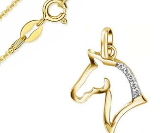 May include: A gold-colored necklace with a horse head pendant. The pendant features a horse head silhouette with a row of small, clear gemstones along the mane. The chain and clasp are also gold-colored, set against a white background.
