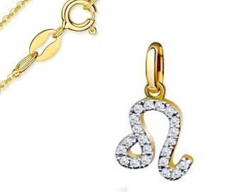 May include: A gold-colored necklace with a pendant featuring the Leo zodiac symbol. The pendant is encrusted with small, clear gemstones. The necklace chain and clasp are also gold-colored.