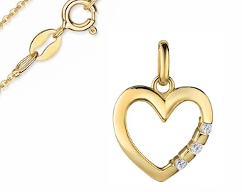 May include: A gold-colored heart pendant necklace with three small, clear gemstones set along the side. The necklace chain and clasp are also gold-colored. The pendant is a simple, elegant design.