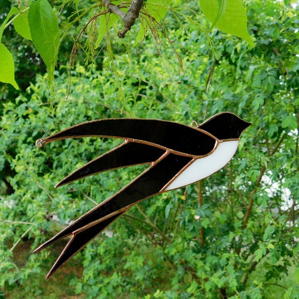 Bird Swallow. Stained glass. Window hangings.