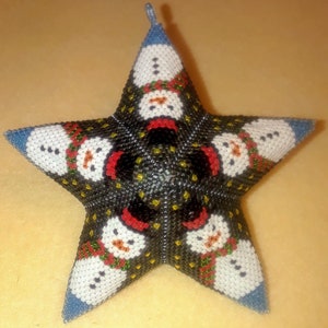May include: A black, white, red, green, and blue beaded star ornament with a snowman design.