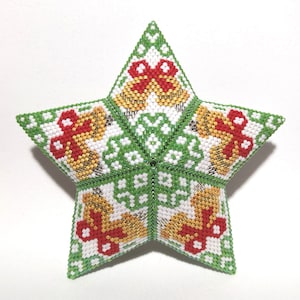 May include: A green, white, red, and gold beaded star ornament with a Christmas theme. The star is made of small beads and has a 3D design.