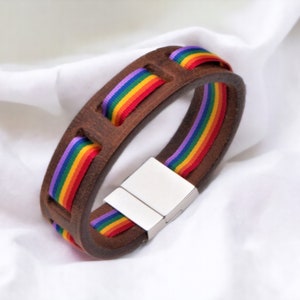Pride Brown Leather Bracelet with pride ribbon woven through the leather to show through very striking.  Stainless Steel Magnetic clasp to close the bracelet.  Great gift for pride month