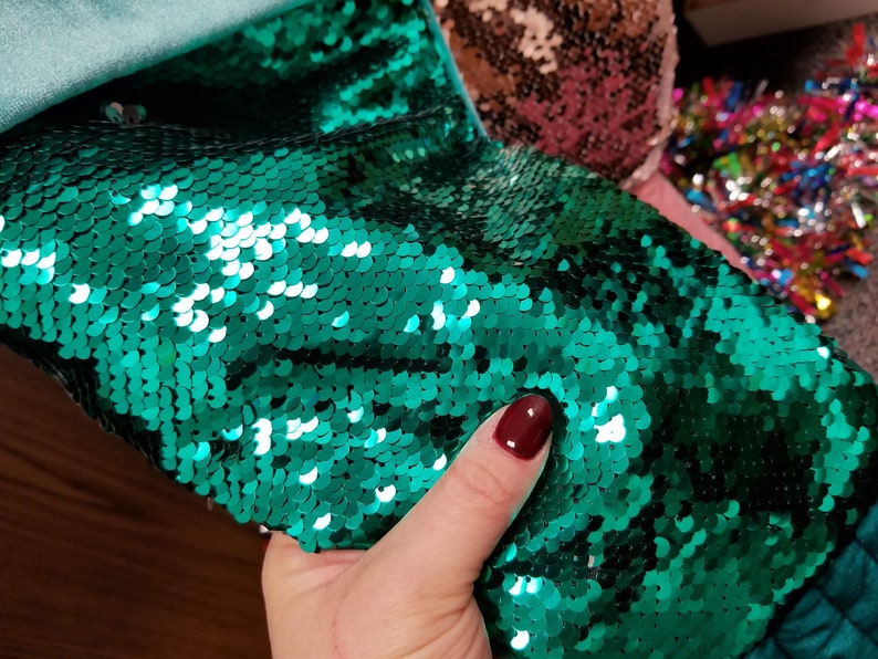 Whimsical Christmas stockings shaped like mermaid tails in green or pink velvet with matching sequins and can be personalized