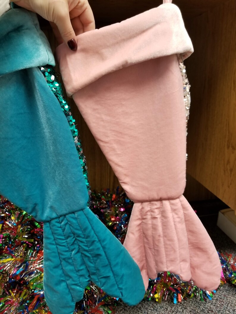 Whimsical Christmas stockings shaped like mermaid tails in green or pink velvet with matching sequins and can be personalized