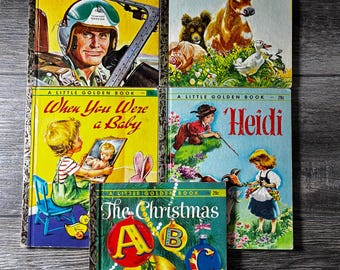 Pode incluir: Uma pilha de cinco livros Little Golden Book vintage. Os títulos incluem "Steve Canyon", "The Cow Went Over The Mountain", "When You Were a Baby", "Heidi" e "The Christmas". As capas apresentam ilustrações coloridas e texto.