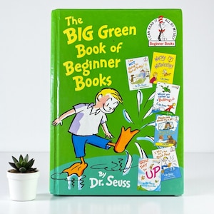 May include: A green hardcover book titled "The BIG Green Book of Beginner Books" by Dr. Seuss. The cover features a cartoon illustration of a boy with orange duck feet splashing in water. Several smaller book covers are also visible.