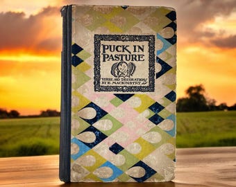 May include: A vintage book titled "Puck in Pasture" with a colorful geometric design on the cover. The book features verse and decoration by E. Mackinstry.