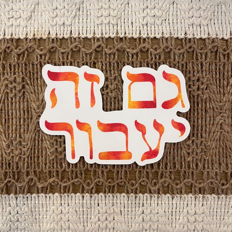 May include: A white sticker with Hebrew text in red and orange gradient colors. The sticker is placed on a textured brown and beige background. The Hebrew text is in a stylized font.