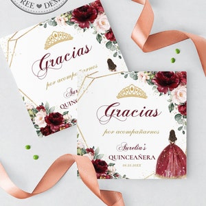 May include: Two thank you cards with a burgundy and gold floral design. The text on the cards reads "Gracias por acompañarnos" and "Aurelia's Quinceañera".