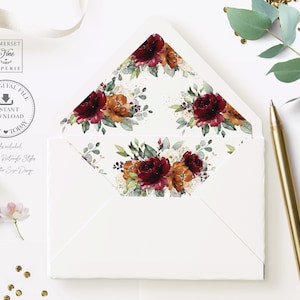 May include: A white envelope with a burgundy, orange, and green floral design on the flap. The envelope is decorated with gold glitter. The text "DIY DIGITAL FILE INSTANT DOWNLOAD PRINT TODAY" is printed on a circle in the upper left corner.