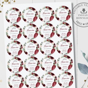 May include: A sheet of 24 round favor stickers with a burgundy, white, and green floral design. The stickers feature a crown, a girl in a burgundy dress, and the text "Gracias por su asistencia a Arelia's Quincea&ntilde;era 24.03.2023".