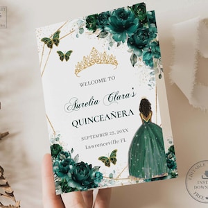May include: A green and gold Quinceañera invitation with a floral design and a silhouette of a girl in a green dress. The text reads "Welcome to Aurelia Clara's Quinceañera September 23, 20XX Lawrenceville FL".