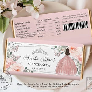 May include: Pink and white chocolate bar wrapper with a floral design and a silhouette of a woman in a pink dress. The wrapper says "Aurelia Clara's Quinceañera 08.25.20XX".