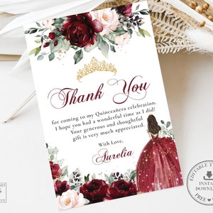 May include: A thank you card with a burgundy and white floral design. The card features a gold crown and the text "Thank You" in a cursive font. The text reads "for coming to my Quinceañera celebration. I hope you had a wonderful time as I did! Your generous and thoughtful gift is very much appreciated. With Love, Aurelia."