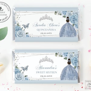 May include: Two blue and white chocolate bar wrappers with a silver glitter background. The wrappers feature a crown, a butterfly, and a girl in a blue dress. The text on the wrappers reads "Aurelia Clara's Quinceañera 08.25.20XX" and "Alexandra's Sweet Sixteen 08.25.20XX".