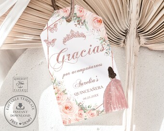 May include: A pink and gold thank you tag with a floral design and a crown. The text reads "Gracias por acompañarnos Aurelia's Quinceañera 06.25.20XX".