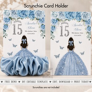 May include: Two rectangular card holders for scrunchies featuring a blue rose floral border, a silver glitter number 15, and an illustration of a person in a blue glitter gown. The text reads Aurelia Clara, Mis Quince Años, and 03.05.20XX.