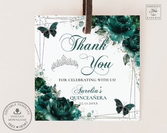May include: A white thank you tag with a silver glitter border and a green floral design. The text "Thank You" is in a cursive font. The text "For celebrating with us! Aurelia's Quinceañera 25.11.20XX" is also on the tag.