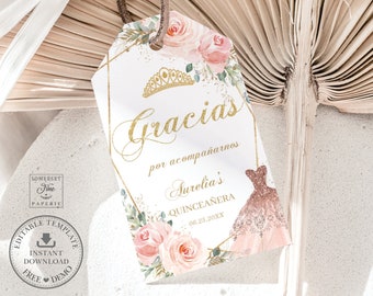 May include: A white thank you tag with a gold border and floral design. The text "Gracias por acompañarnos Aurelia's Quinceañera 06.25.20XX" is printed on the tag.