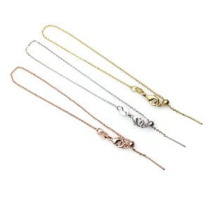 May include: Three delicate chains with adjustable lengths, each featuring a small ball and a thin metal rod. The chains are available in gold, silver, and rose gold.